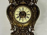a clock hanging on the wall with a white background