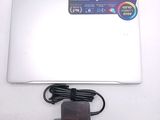 a white laptop with a charger and a power cord