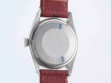 a close up of a wrist watch on a white surface