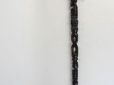 a black umbrella with a wooden handle on a white wall