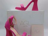 a close up of a pair of pink high heeled sandals