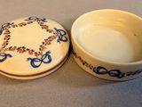 a small bowl with a lid sitting on a table