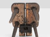 a small wooden chair with two legs on a white surface