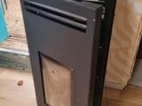a black stove sitting on a hard wood floor in a room