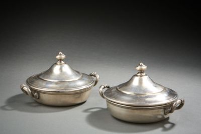 pair of silverplated dishes with handles and handles on a table