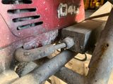 a close up view of a red machine in a garage
