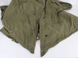 an image of a green jacket with buttons on the collar