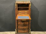 an old wooden desk with drawers and a blue top