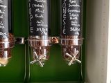 a shelf that has three drinks and a menu on it