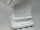 a white bust of a man on display on a table
