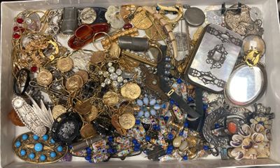 a white box filled with lots of jewelry and a pair of scissors