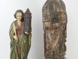 pair of wooden statues of a woman and a man with a bird cage