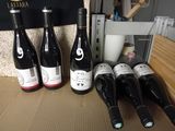 several bottles of wine are lined up on a table