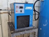 a blue air dryer sitting next to a blue water tank