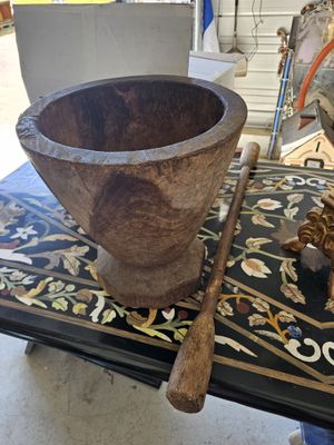 a wooden bowl and a wooden baseball bat on a table