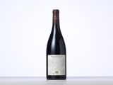 a bottle of red wine sitting on top of a table