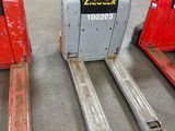 two red forklifts sitting next to each other in a warehouse