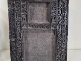 a black picture frame with carvings on it