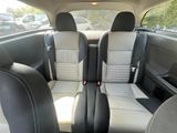 two seats in the back of a car that are black and white