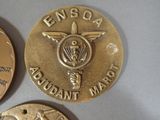 two gold coins with the emblem of an air force and a coin with the emblem of an air force
