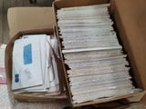 a box full of mail sitting on the floor