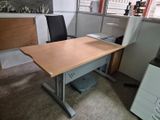 a desk with a chair and a printer in the corner