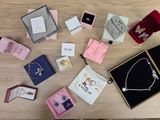 a lot of jewelry sitting on a table next to each other