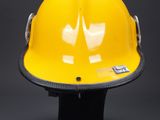 a yellow hard hat sitting on top of a black table