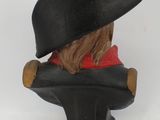 a figurine of a man wearing a hat and a coat