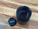 a camera lens sitting on a wooden table next to a camera cap