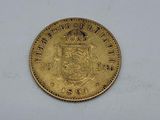 a close up of a gold coin on a white surface