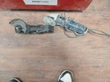 a person standing next to a tool on a wooden floor