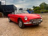 an image of a red convertible car parked in a parking lot