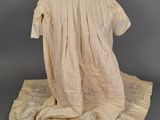 an image of a dress on a mannequin stand on a gray surface