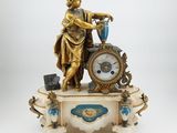 a statue of a woman with a clock on a table