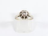 a close up of a diamond ring on a white surface