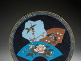 an image of a blue and black plate with flowers and birds on it