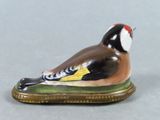 a figurine of a bird sitting on top of a table
