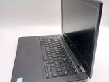 a laptop computer sitting on a table with a keyboard