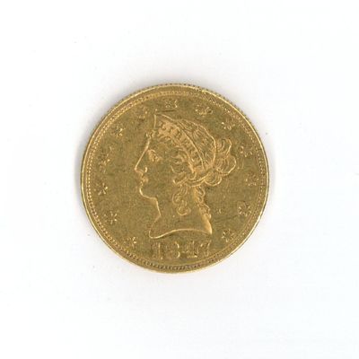 a gold coin with a picture of a woman on it