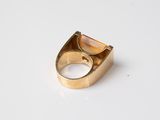 an image of a gold ring with a stone in the middle