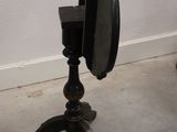 a small black table with a mirror on it