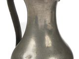 a silver pitcher with a bird on it on a white background