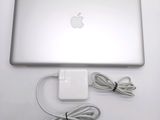 an apple laptop with a charger attached to it