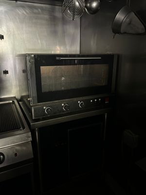 two ovens and a stove in a small kitchen