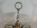 a silver tray with three glasses and a bottle on it
