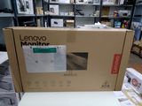 a laptop computer sitting on top of a box in a store