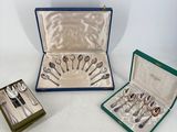 several different types of silverware in a case on a white surface