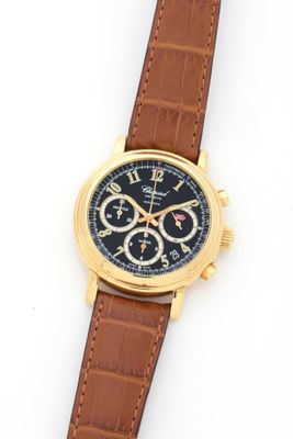 an image of a close up of a wrist watch on a white surface