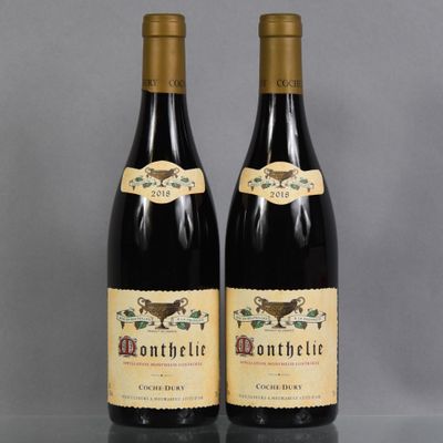 two bottles of wine sitting next to each other on a table